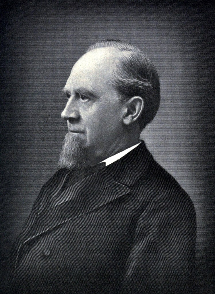 Charles Pratt in black and white. He is a bearded man wearing a suit.