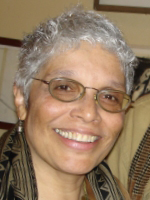 Pat Cummings smiling for the camera. She is wearing glasses.