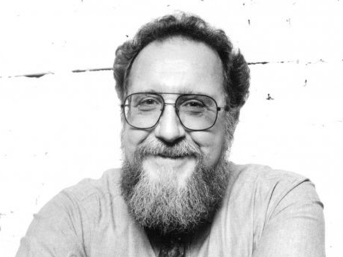 Ron smiling at the camera. He is a bearded man wearing glasses.