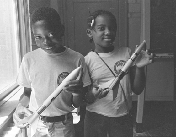 two students holding rockets