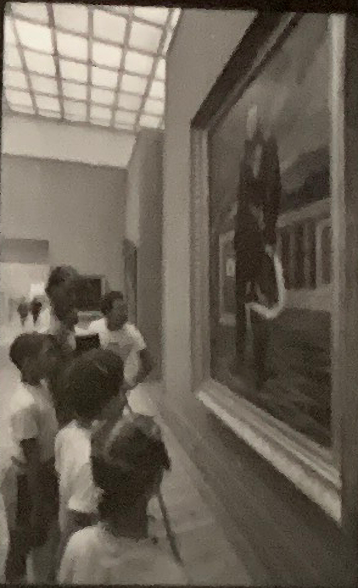 Students observing a painting of a standing man inside the Metropolitan Museum of Art