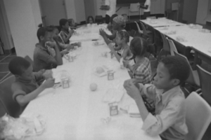 students seated at a table eating a meal together