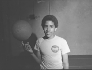 Student balancing a basket ball on his index finger